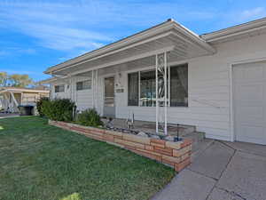 View of front of home with a front yard and a large front proch