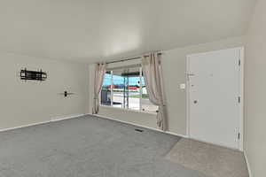 Huge front window with lots of light Shades and Curtains