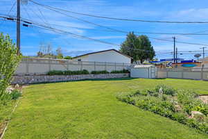 View of yard with a storage shed and an outdoor structure Fully fenced and private