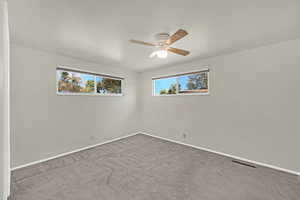 Spacious second bedroom with ceiling fan