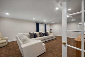 Living room featuring carpet floors, recessed lighting, and baseboards
