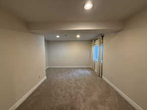 Spare room featuring recessed lighting and carpet floors