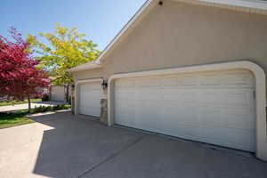 Garage featuring concrete driveway