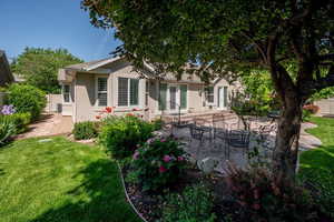 Back of property featuring stucco siding, a patio, and french doors