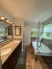 Bathroom with plenty of natural light, double vanity, and a whirlpool tub