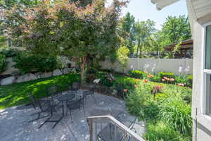Fenced backyard with outdoor dining space and a patio
