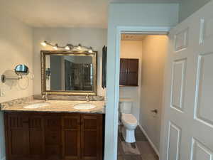 Full bath featuring double vanity and a shower stall
