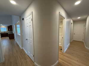 Hall with recessed lighting and light wood-style flooring