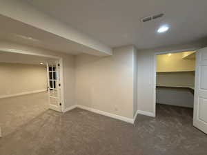 Finished below grade area with recessed lighting and carpet flooring