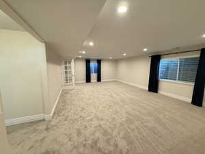 Empty room featuring recessed lighting and light colored carpet