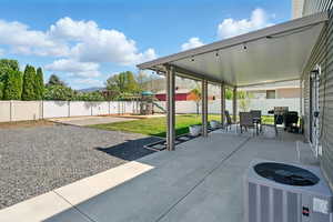 View of patio featuring a playground, central AC unit, and outdoor dining area