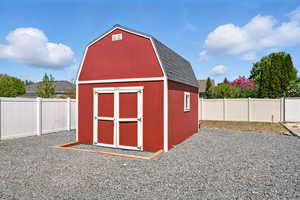 View of shed with a fenced backyard