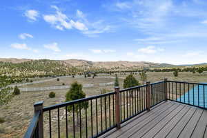 Wooden deck featuring a mountain view and a rural view