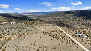 View of rural area with a mountain backdrop and a desert landscape