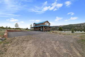 View of front of home featuring covered porch, driveway, and a mountain view