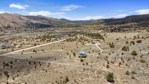 Overview of rural landscape featuring a desert landscape and a mountainous background