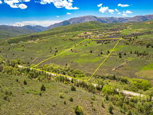 Aerial view of property with approximate property parcel outlined featuring a mountain backdrop