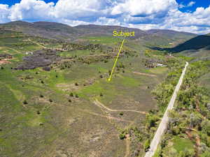 Aerial overview of property's location featuring a mountain backdrop