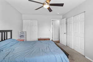 Bedroom with carpet, baseboards, and a ceiling fan