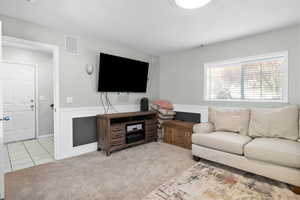 Living room with light carpet and light tile patterned floors