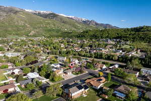 Aerial view of property's location with nearby suburban area and a mountainous background