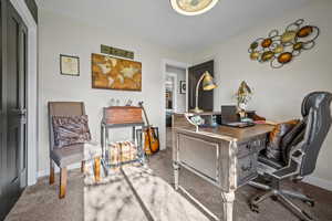 Office space with carpet and baseboards
