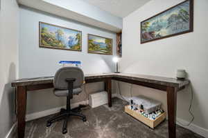 Carpeted office with baseboards
