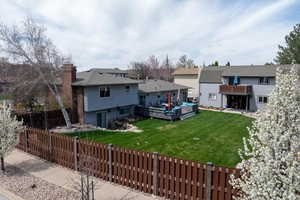 Rear view of property with a wooden deck, an outdoor hangout area, and a chimney