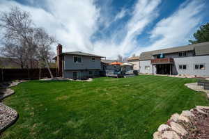 View of yard with a deck and an outdoor living space