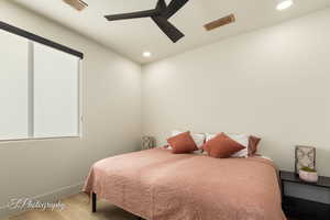 Bedroom featuring wood finished floors, baseboards, recessed lighting, and ceiling fan