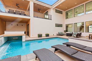 View of pool with an outdoor hangout area, ceiling fan, a patio, and a swimming pool