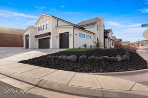 View of property exterior featuring stucco siding, driveway, and a garage