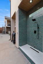 Full bath with a tile shower and concrete flooring