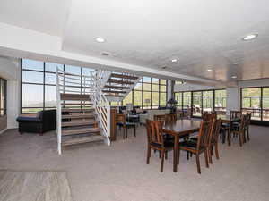 Dining area of Sky Room featuring carpet, a textured ceiling, recessed lighting, and stairway