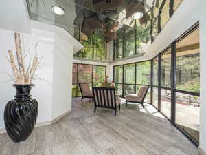 Sunroom / solarium with a towering ceiling