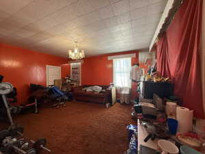 Misc room with carpet flooring, a chandelier, and radiator