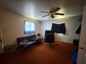 Sitting room featuring carpet floors and ceiling fan