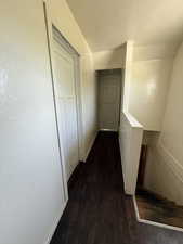 Hallway with wood finished floors and baseboards