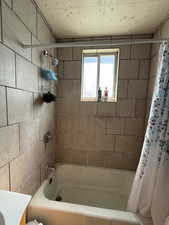 Full bath featuring shower / tub combo with curtain and vanity