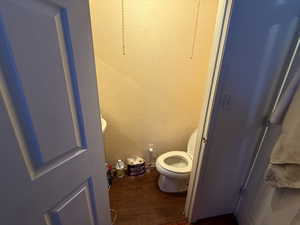Bathroom with wood finished floors and toilet