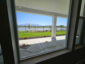 Entryway with a water and mountain view