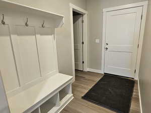 Mudroom with wood finished floors and baseboards