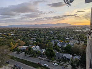 Aerial view of property and surrounding area featuring a mountain backdrop