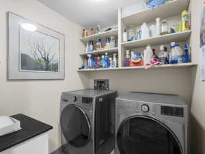 Clothes washing area featuring independent washer and dryer