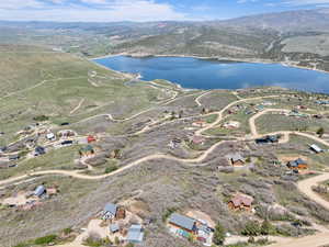 Aerial view of property's location featuring a water and mountain view