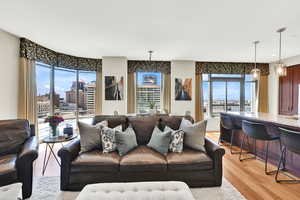 Living area with light wood-style floors and a city view
