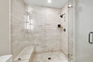 Full bath with a stall shower, toilet, and recessed lighting