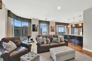 Living room featuring light wood finished floors, recessed lighting, and baseboards