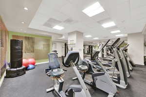 Workout area featuring a drop ceiling