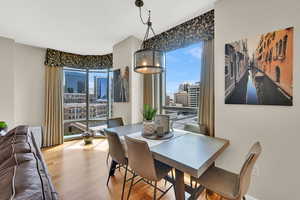Dining space with wood finished floors and a view of city
